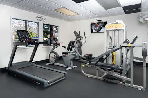 Fitness center with cardio and strength training equipment at Woodbend Apartments, Alta Loma, 91701