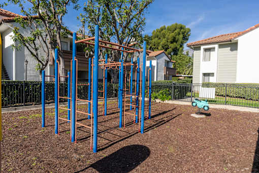 Outdoor fitness equipment with monkey bars and rings at Woodbend Apartments, Alta Loma, California