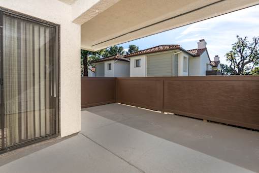 Private patio with wood privacy fence at Woodbend Apartments, California