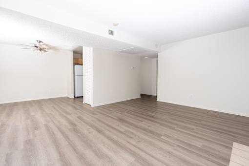 Spacious living area with woodstyle flooring at Woodbend Apartments, Alta Loma