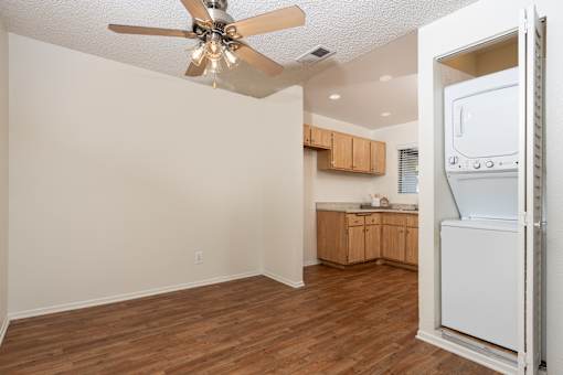 Open floor plan with kitchen and laundry closet at Woodbend Apartments, California, 91701
