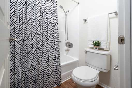 Bathroom with herringbone pattern shower curtain at Woodbend Apartments, Alta Loma, 91701