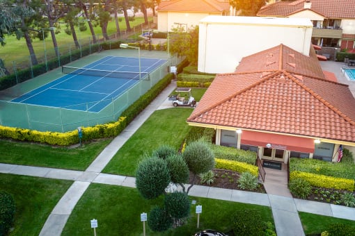 Leasing office and tennis court aerial view at Woodbend, Alta Loma, CA