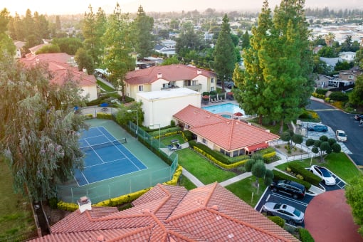Aerial view of tennis court, parking and leasing office at Woodbend, California