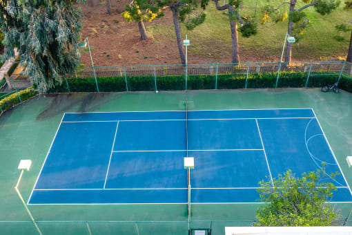 Two-Bedroom Apartments in Alta Loma, CA - Woodbend - Tennis Court with Fenced-in Area and Trees at Woodbend, Alta Loma, 91701