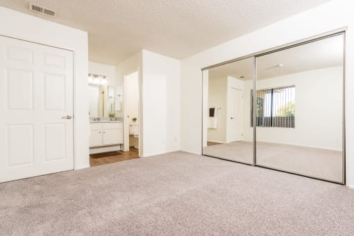 Bedroom with large mirror, closet and sink at Woodbend, Alta Loma, California