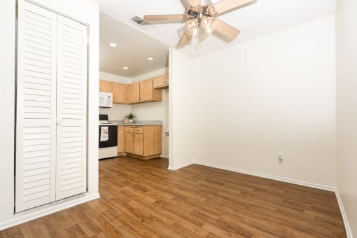 Dining area with ceiling fan and kitchen at Woodbend, Alta Loma, CA, 91701