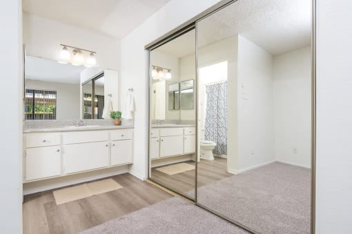 Bathroom sink and large mirror and closet at Woodbend, Alta Loma, CA, 91701
