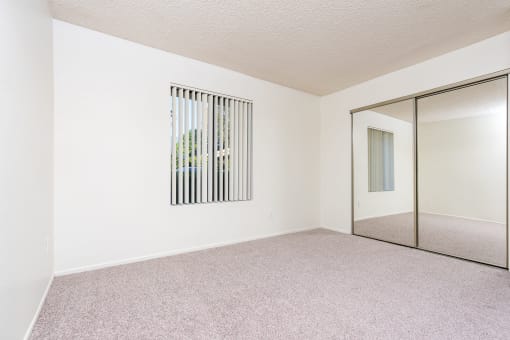 Bedroom with window and closet at Woodbend, Alta Loma