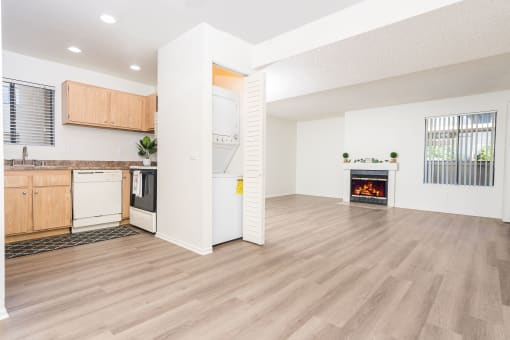 Livingroom and kitchen with in unit washer and dryer at Woodbend, Alta Loma, California