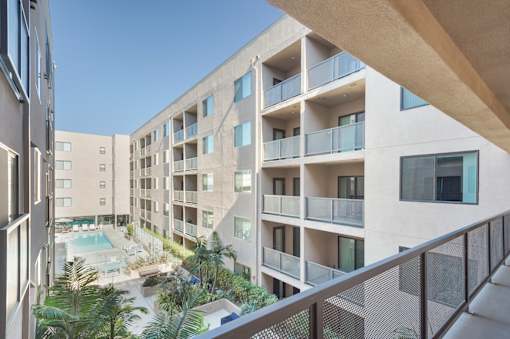 A modern apartment complex with a pool and balconies at Wilshire Valencia Apartment, Los Angeles, 90017