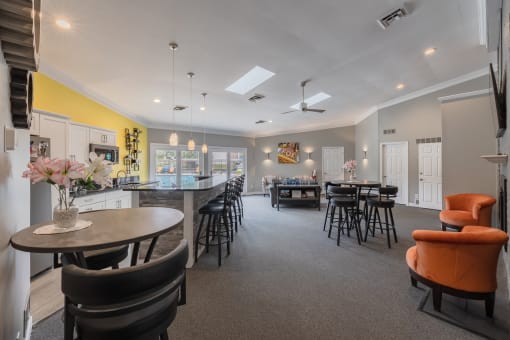 a clubhouse with a dining area and a bar with chairs and tables