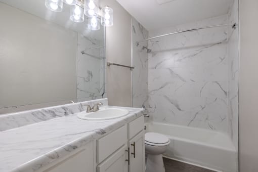 a bathroom with a sink and a tub and a toilet