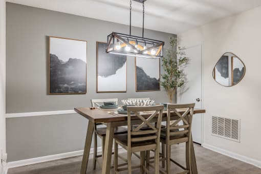 our spacious dining room with a table and chairs and a chandelier