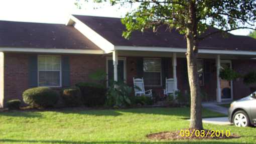 A house with a tree in front of it.