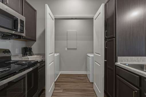 A kitchen with dark wood cabinets and a white refrigerator.