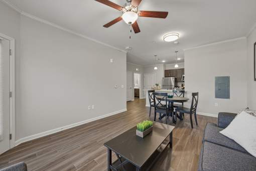 A living room with a dining table and chairs.