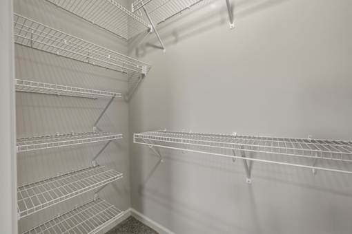 Empty shelves in a white refrigerator.