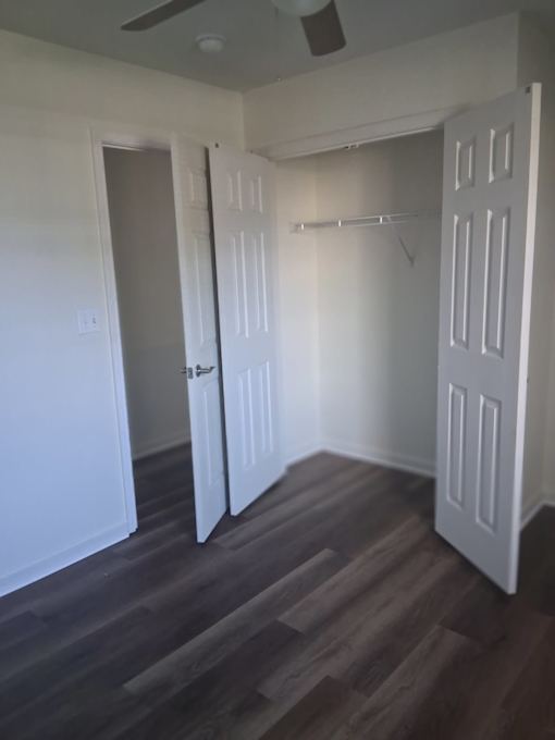 A room with a white door and a white wall.