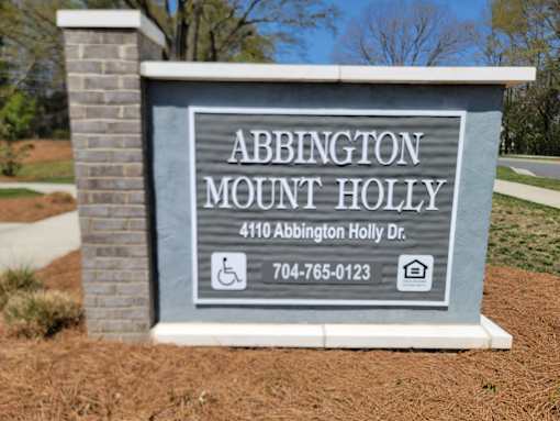 A sign for Abbington Mount Holly with a phone number and address.