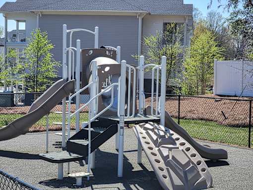 A playground with a slide and monkey bars.