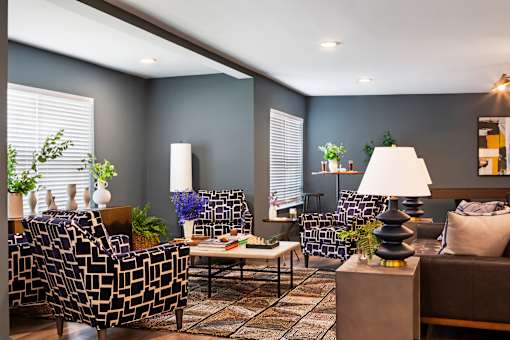 A living room with a patterned sofa, a coffee table, and a lamp.