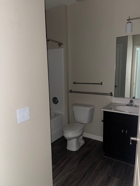 A bathroom with a toilet, sink, and bathtub.