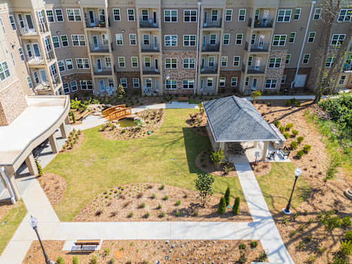 A large apartment complex with a courtyard and a small pavilion.