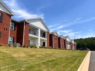 A row of red brick houses with white trim and windows.