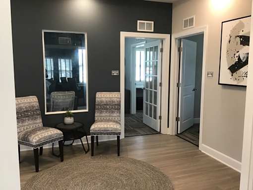 A room with a black wall and a mirror.
