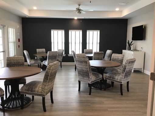 A room with a table and chairs set up for a meeting.
