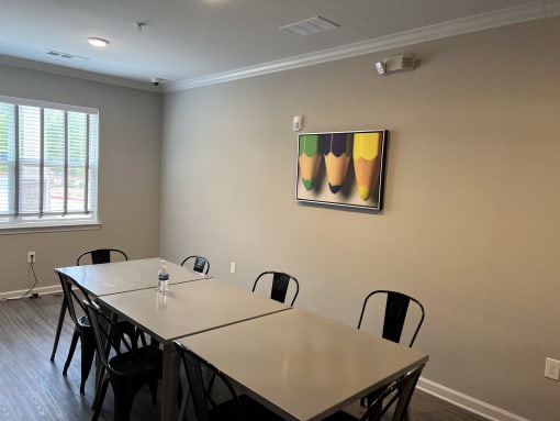 a meeting room with a large table and chairs