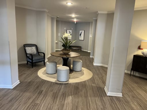 a room with a table and chairs in the middle of it