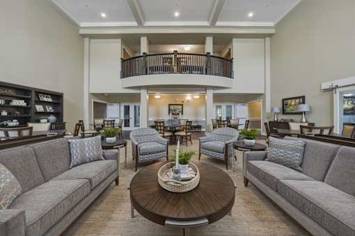 A living room with a balcony and a coffee table.