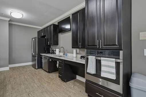 A kitchen with dark wood cabinets and stainless steel appliances.
