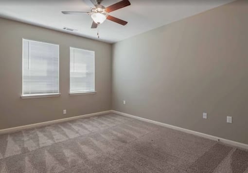 A staircase with a white railing and a carpeted floor.