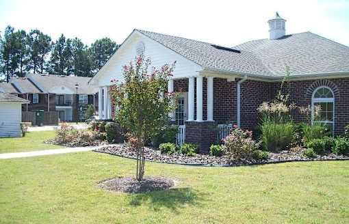 A white house with a red brick porch.