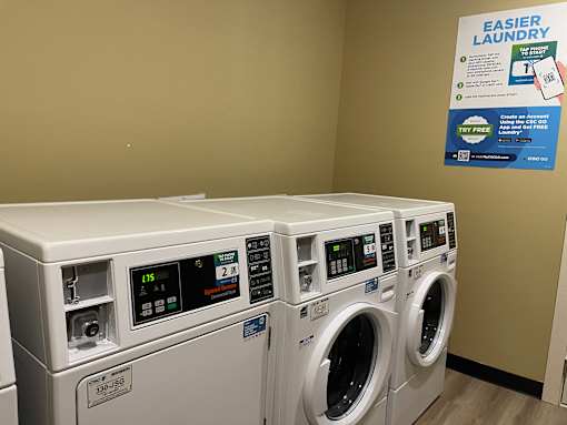 A row of washing machines in a laundromat.