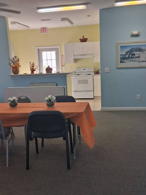 A room with a table and chairs in it.