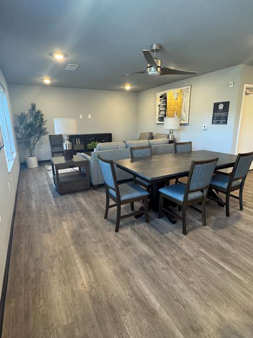 A modern interior with a wooden wall and a white table.