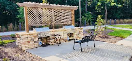 A wooden pergola with a bench underneath it.