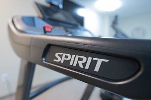 A close up of a black treadmill with the word "SPIRIT" on the side.