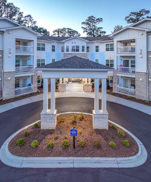 A gazebo is in the middle of a courtyard surrounded by apartment buildings.