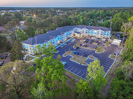 A large building with a parking lot in front of it.