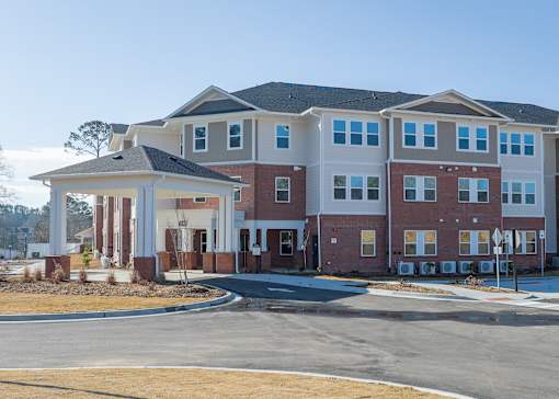 A large multi-story building with a covered walkway in front.