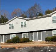 A building with grey siding and white trim.
