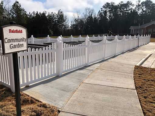 A white picket fence surrounds the Fairfield Community Garden.