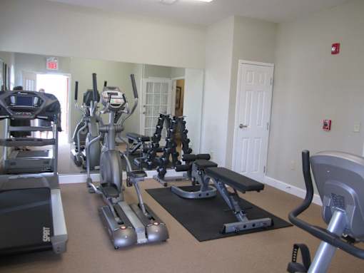 A gym with treadmills, exercise bikes and other equipment.