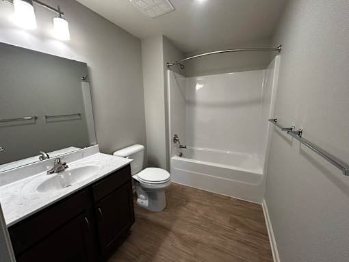 A bathroom with a toilet, sink, and bathtub.