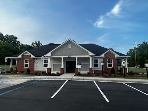 A building with a parking lot in front of it.